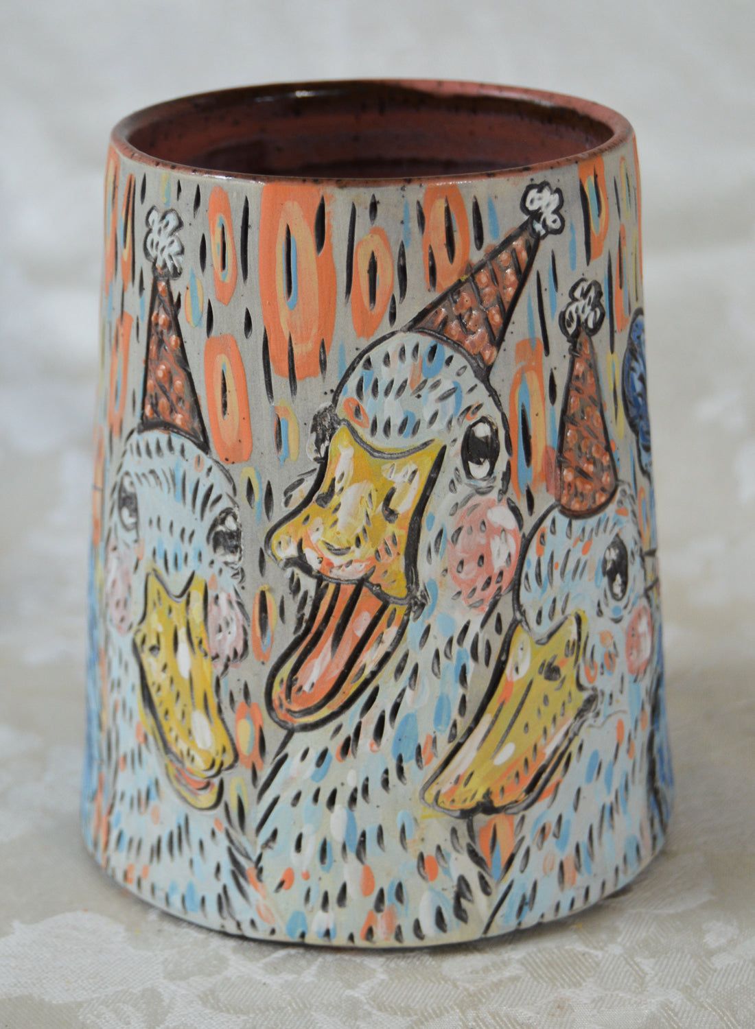 Handmade ceramic stoneware mug with cute ducks wearing party hats design