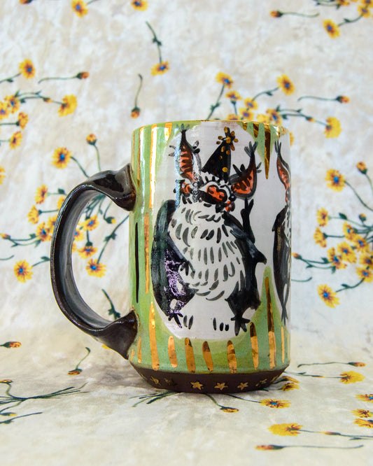 Ceramic mug with a cute cartoon bat design with gold stripes and dots