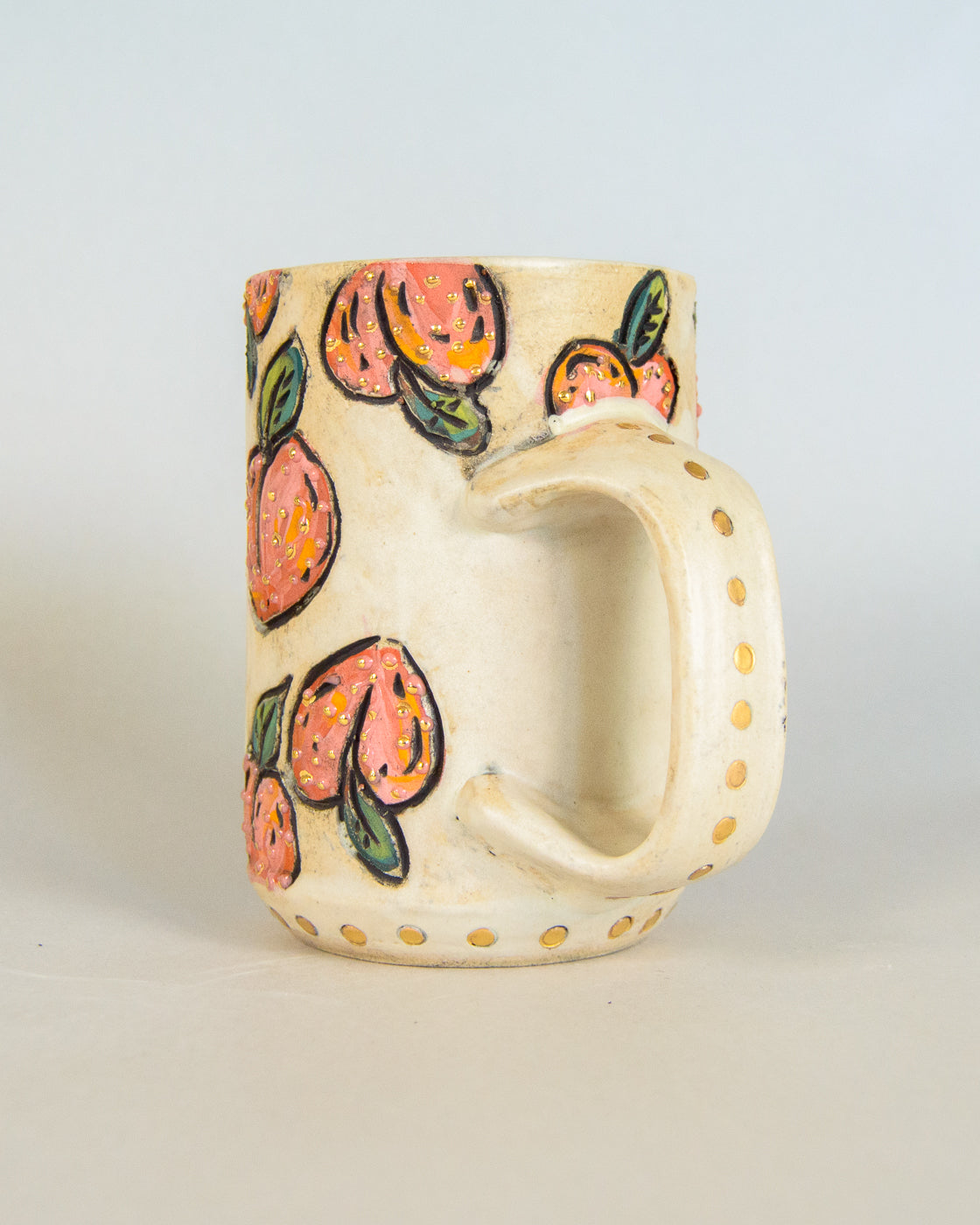 Ceramic mug with peach pattern on a light gray background