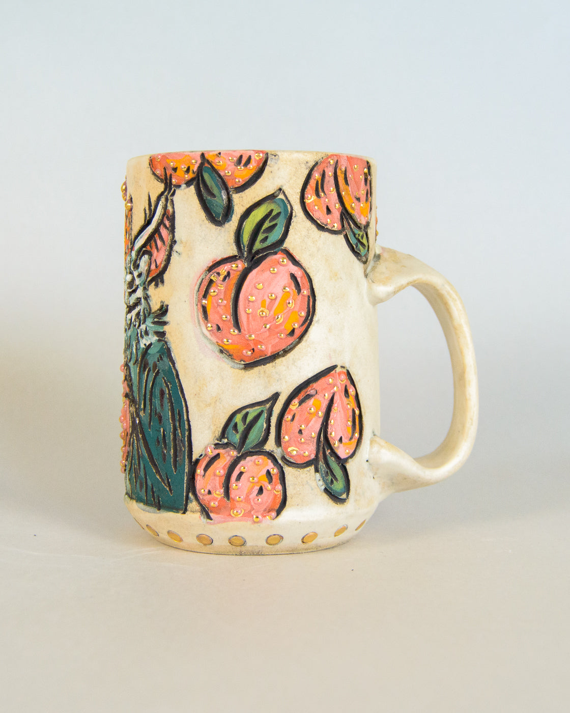 Ceramic mug with peach design on a light gray background
