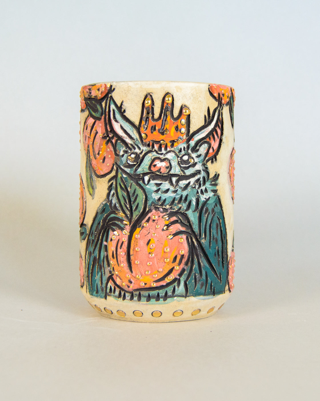 Ceramic mug with a colorful bat design on a white background