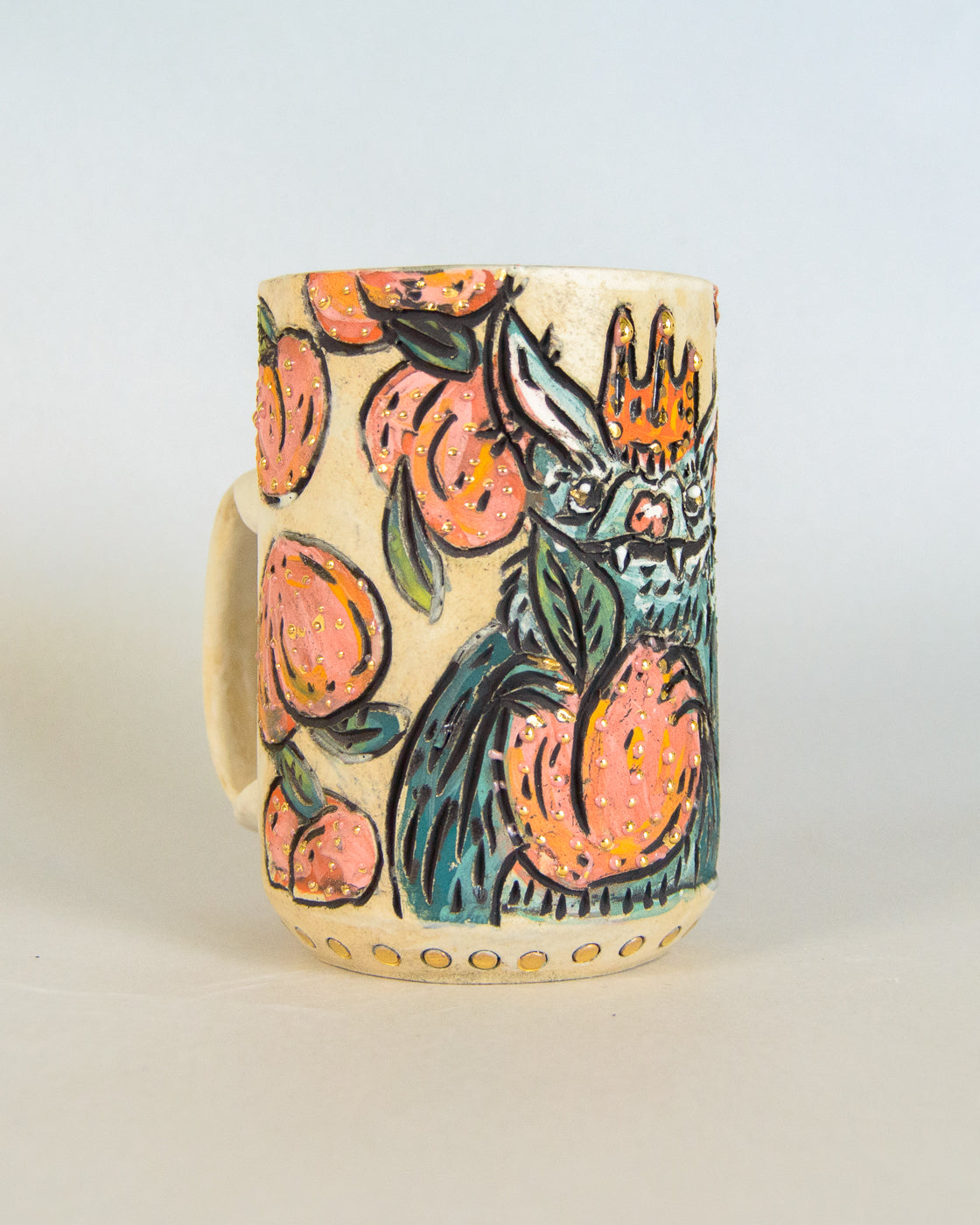 Ceramic mug with bat and peach design on a light background