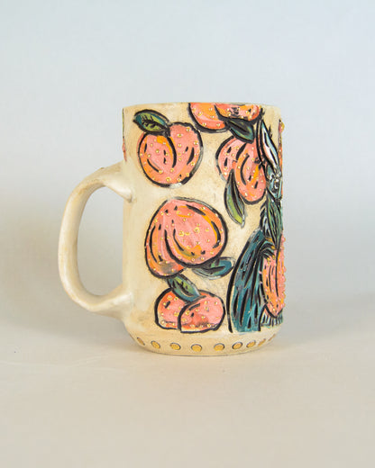 Ceramic mug with peach and bat design on a light background