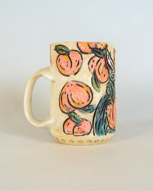 Ceramic mug with peach and bat design on a light background