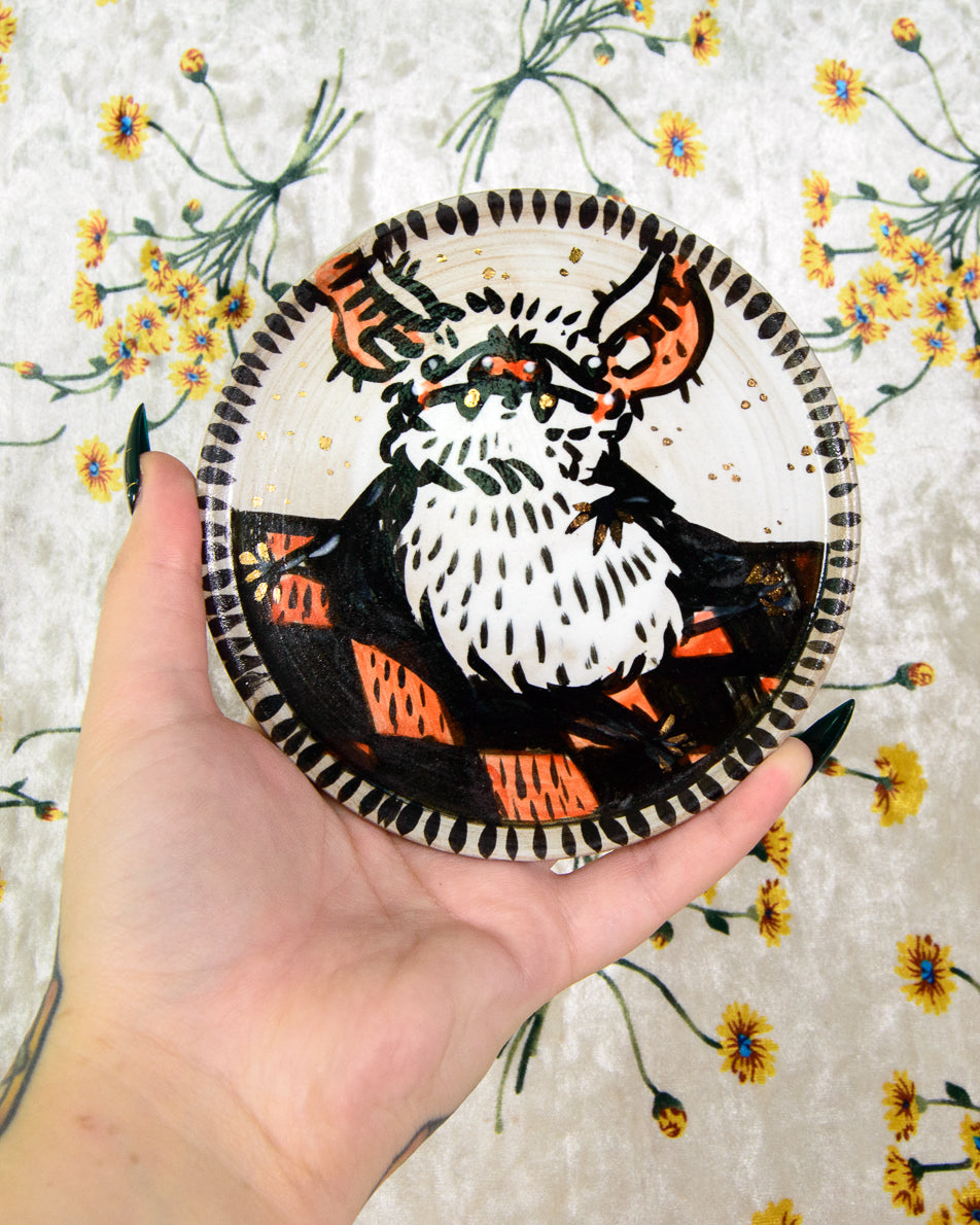round ceramic coaster with a cartoon cute bat on a picnic blanket