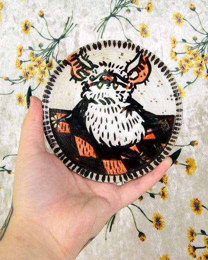 round ceramic coaster with a cartoon cute bat on a picnic blanket