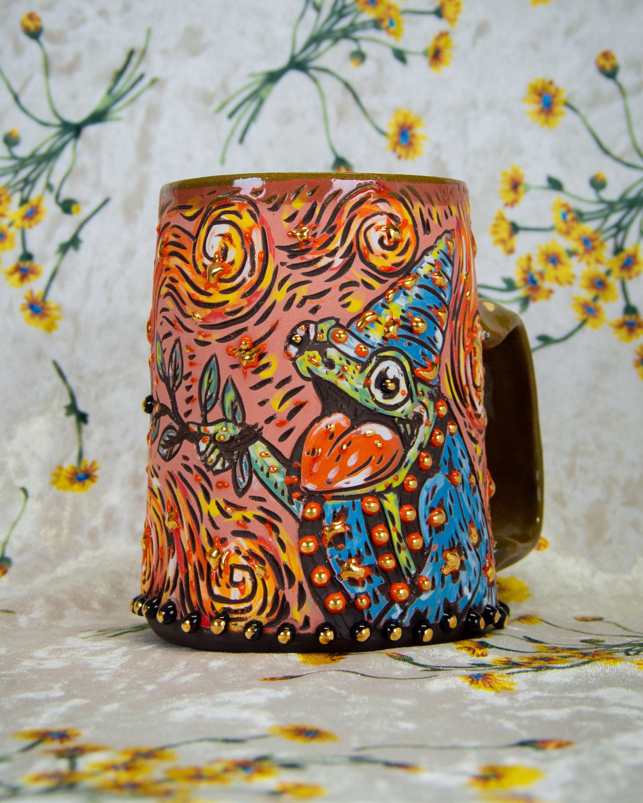 Handmade ceramic mug with a colorful magic frog wizard design