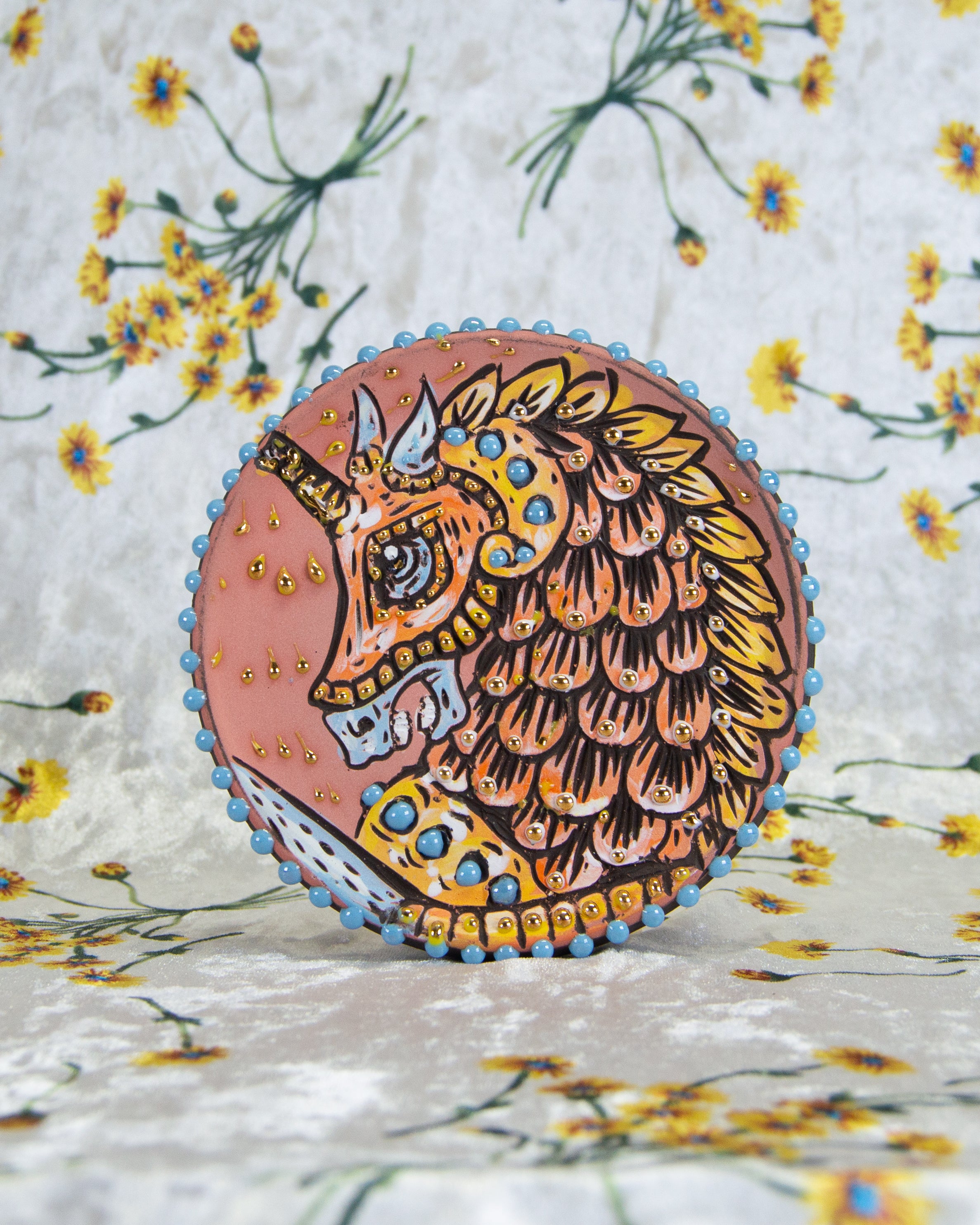 Handmade ceramic stoneware coaster decorated with a pastel carousel horse design