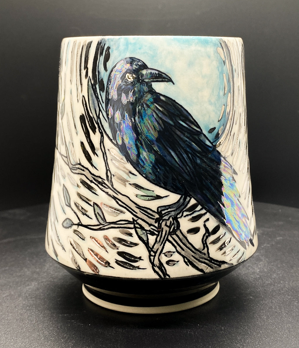 Handmade ceramic porcelain mug with a blue crow and branch design