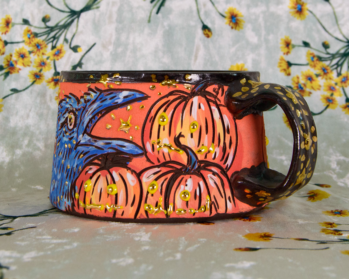 Decorative mug with pumpkins and floral designs on a floral background