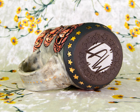 Ceramic mug with a decorative star pattern and LAW signature of Leigh Weinberg, the artist of Lawful Studios