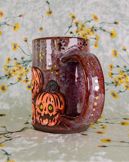 Ceramic mug with Halloween design of pumpkins on a floral background