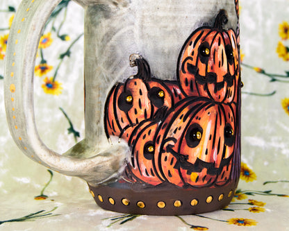 Ceramic mug with hand-painted halloween pumpkins on a floral background