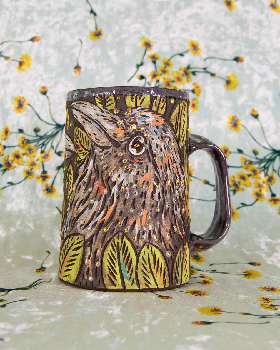 Ceramic mug with bird design on a floral background