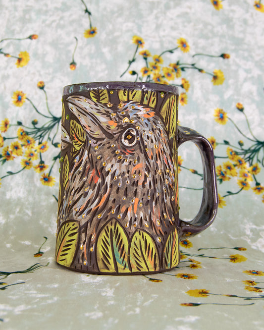 Ceramic mug with bird design on a floral background