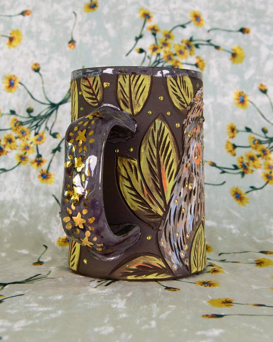 Decorative mug with leaf pattern on a floral background