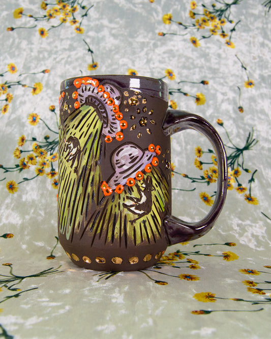 Black Stoneware mug with cartoon designs of purple ufos and orange lights and floating cows