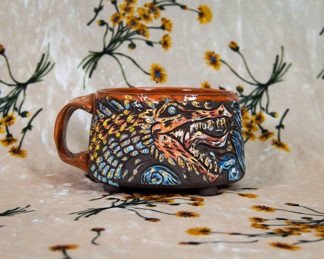 Handmade ceramic stoneware mug with a dragon breathing fire design
