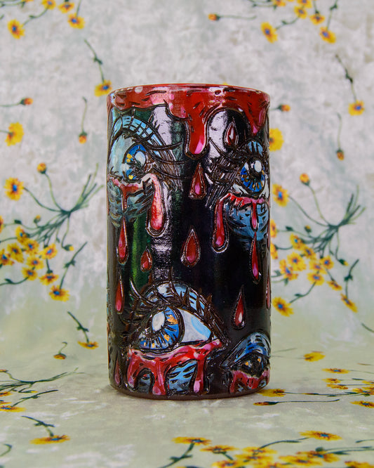 Ceramic highball cup decorated with crying blue and gold eyes. 