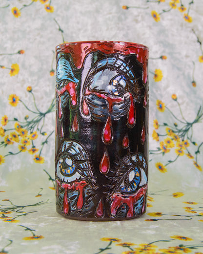 Ceramic highball cup decorated with crying blue and gold eyes. 