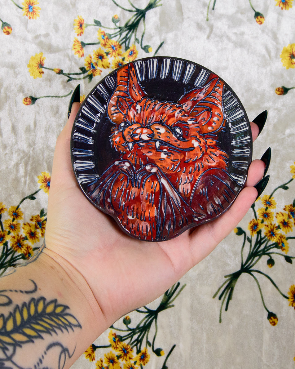 Ceramic spoon rest with a cute cartoon bat design