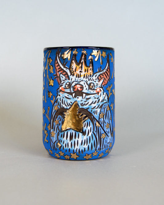 Ceramic mug with a bat and star design on a blue background