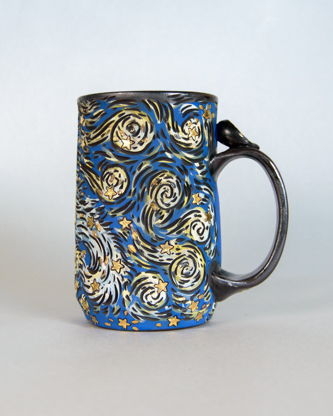 Mug with a starry night design on a light gray background