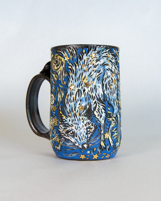 Mug with a design of a fox and star patterns on a white background