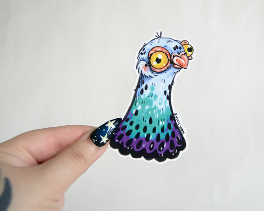 Colorful cartoon-like pigeon sticker held by a hand on a white background