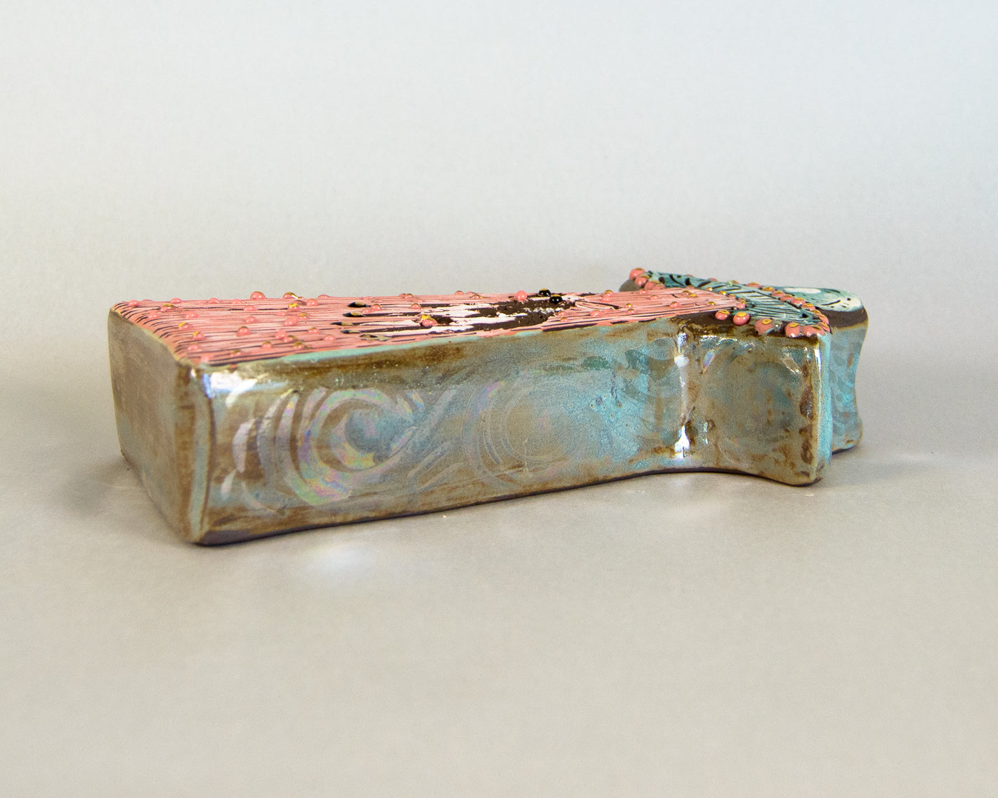 Ceramic vase with multicolored glaze on a white background