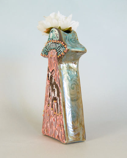 Ceramic vase with artistic design and white flowers on a light gray background