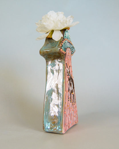 Decorative vase with a floral arrangement on a light gray background