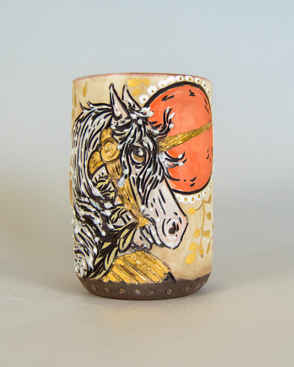 ceramic mug with unicorn design and gold leaf accents