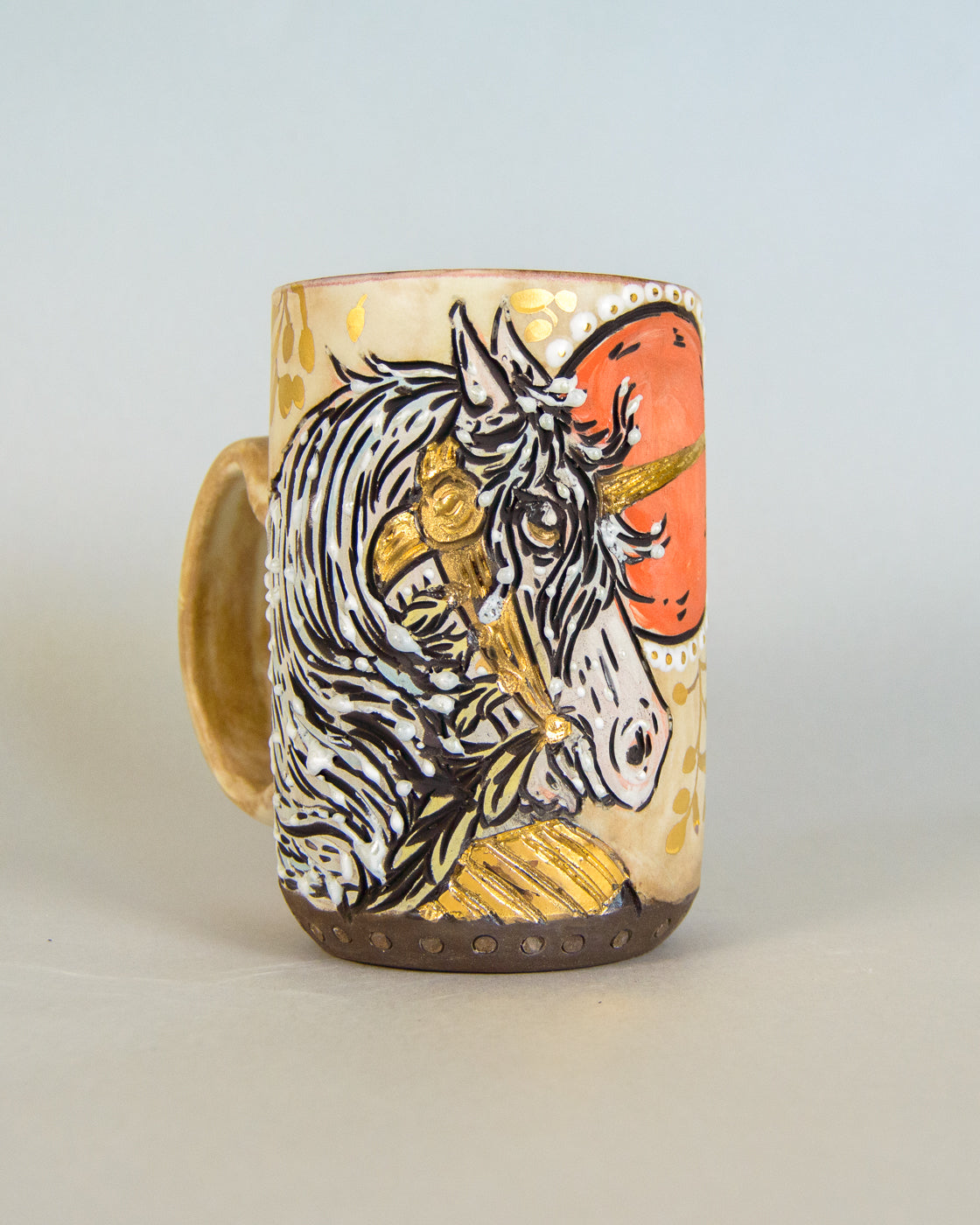 Ceramic mug with a unicorn design on a light gray background