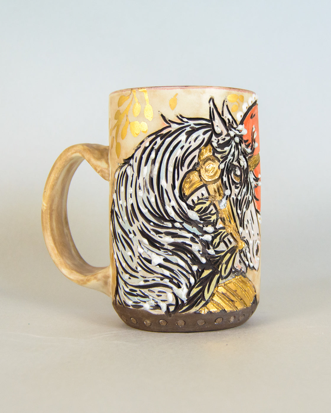Ceramic mug with a unicorn design on a light gray background
