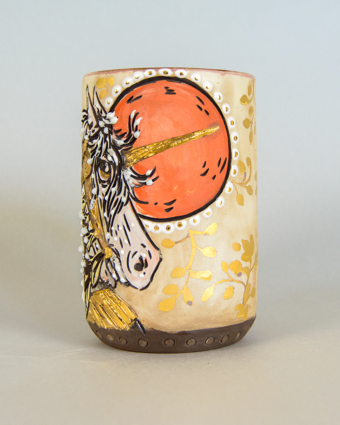 ceramic mug with unicorn design on a light gray background