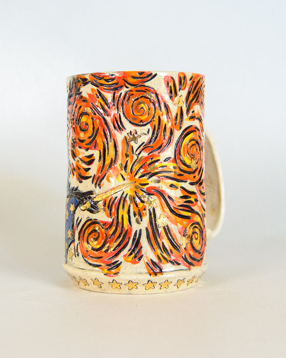 Decorative candle with orange and black flame pattern on a white background