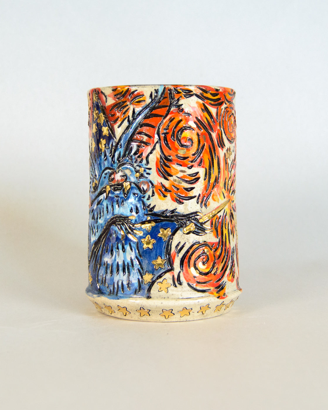 Ceramic mug with artistic design of a wizard bat and flame patterns on a white background