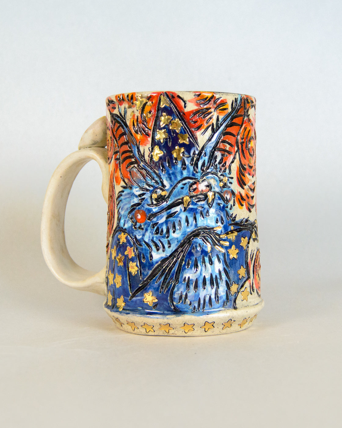 Ceramic mug with colorful animal design on a white background