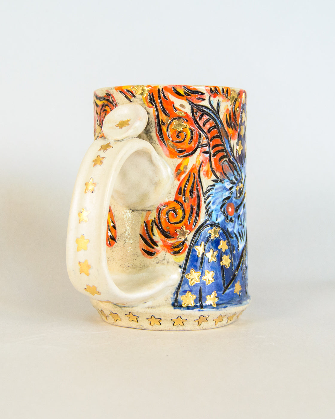 Ceramic mug with colorful abstract design on a white background