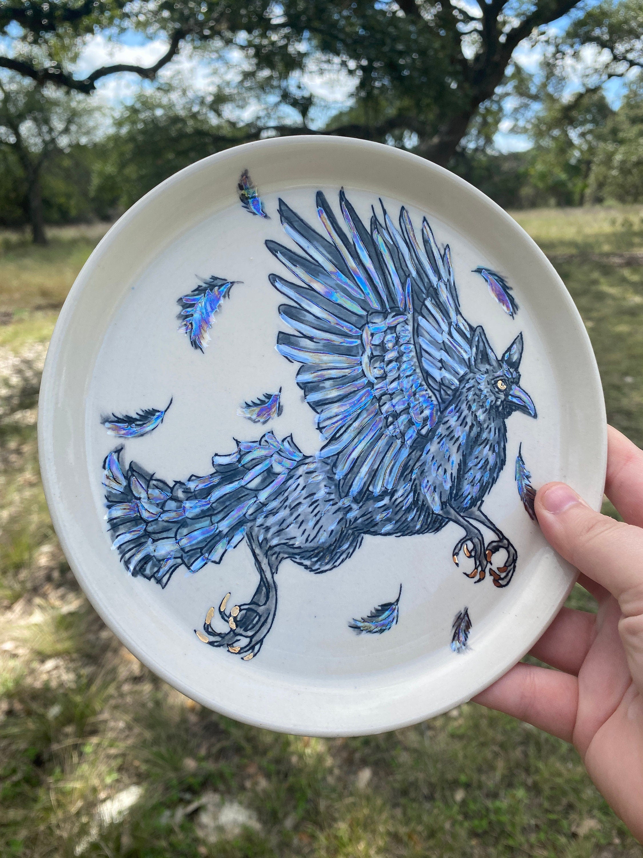 Handmade porcelain cryptid plate of a crow gryphon and rainbow pearl luster accents